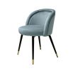 Pair of blue velvet dining chairs with black legs and brass tipped feet.