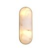 A luxurious wall lamp by Eichholtz with a translucent alabaster shade and an antique brass finish