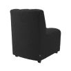 A deep fluted dining chair upholstered in a boucle black fabric