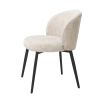 A luxury set of dining chairs from Eichholtz with a beige upholstery and tapered black legs
