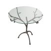 A unique and stylish centre table by Eichholtz with a clear, round table top and a bronze finished, branch-like tripod base