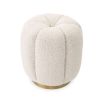 A stunning stool by Eichholtz with a boucle cream upholstery, deep channel stitching and a brushed brass base