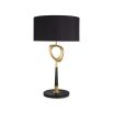 A contemporary table lamp by Eichholtz with a stylish design featuring an antique brass finish, an open free shape and a black cylindrical shade