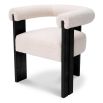 Sleek boucle dining chair with round back and black wooden legs