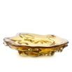 Contemporary bowl featuring free-flowing shape crafted from yellow hand-blown glass