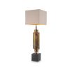 A stylish table lamp by Eichholtz with a structural design, stainless steel composition and vintage brass finish