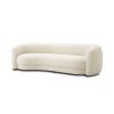 A chic and curvy sofa by Eichholtz with a luxury boucle upholstery