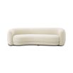 A chic and curvy sofa by Eichholtz with a luxury boucle upholstery