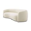 A chic and curvy sofa by Eichholtz with a luxury boucle upholstery