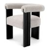Sleek boucle dining chair with round back and black wooden legs