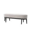 Grey boucle upholstered bench with gentle curves and three black tapered legs on either side