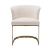 Modern, boucle upholstered dining chair with brushed brass base