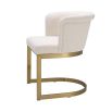 Modern, boucle upholstered dining chair with brushed brass base