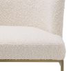 Modern, boucle upholstered dining chair with brushed brass base