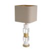 A stylish table lamp by Eichholtz featuring a luxury linen mix shade and marble, crystal glass base with an antique brass finish 