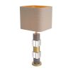 An elegant table lamp featuring a linen mix shade with a marble, crystal glass base and antique brass finish 