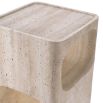 A sculptural side table by Eichholtz crafted from travertine with a Mid-Century appeal and multiple storage levels