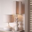 Beautiful table lamp with sweeping curves and natural linen shade with subtle embroidery