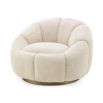 A beautiful swivel chair by Eichholtz with gentle curves, a soft-touch teddy upholstery and a brushed brass base