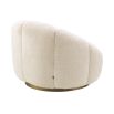 A beautiful swivel chair by Eichholtz with gentle curves, a soft-touch teddy upholstery and a brushed brass base