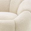 A beautiful swivel chair by Eichholtz with gentle curves, a soft-touch teddy upholstery and a brushed brass base