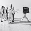 A monochrome photograph by Joseph Scherschel that depicts a group of spectators during a motorsport race during the 1950s