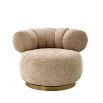 Dazzling swivel chair with brass base and sumptuous soft fabric