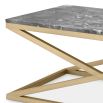 A stylish coffee table with cross-details and a grey marble surface 