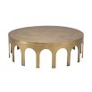 A statement coffee table by Eichholtz with arched details and a vintage brass finish