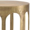 A striking side table by Eichholtz with arched details and a vintage brass finish