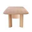 A natural oak veneer dining table by Eichholtz featuring subtle asymmetrical table legs