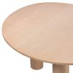A rounded dining table by Eichholtz with a natural finish