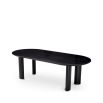 A luxury black dining table by Eichholtz with offset playful legs