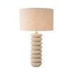 Playful and elegant table lamp with travertine ring design and brass accents