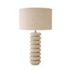 Playful and elegant table lamp with travertine ring design and brass accents