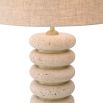 Playful and elegant table lamp with travertine ring design and brass accents