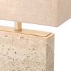 Striking, modern travertine table lamp with brass accents