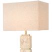 A modern and neutral floor lamp by Eichholtz with a boxy shape shade and travertine finish