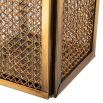 A luxury vintage brass hurricane by Eichholtz with a rattan finish