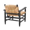 Bold black frame armchair with rustic woven backrest and seat