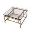 Square geometric coffee table with brass legs and glass top
