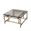 Square geometric coffee table with brass legs and glass top