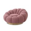 A luxurious swivel chair by Eichholtz with a flower-like design and brushed brass base