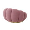 A luxurious swivel chair by Eichholtz with a flower-like design and brushed brass base