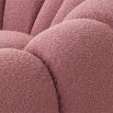 A luxurious swivel chair by Eichholtz with a flower-like design and brushed brass base