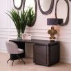 The Modesto Desk, crafted from mocha oak veneer with brushed brass accents, blends rustic charm and contemporary style, offering a spacious, elegant work surface.