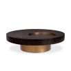 Round coffee table with dark wood top, sunken circular detail and gold accents