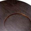 Round coffee table with dark wood top, sunken circular detail and gold accents