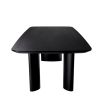 A luxury black veneer dining table by Eichholtz with offset playful table legs
