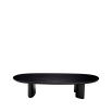 A sophisticated coffee table by Eichholtz with playfully asymmetrical legs and a beautiful black finish